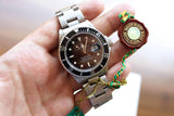 Rolex Submariner Date luxury watch with silver steel bracelet and official seal