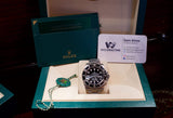 Pre-owned Rolex Submariner watch in green box with warranty booklet and business card