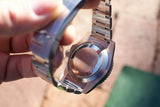 Close-up of the stainless steel case back and bracelet of a luxury Swiss watch
