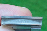 Close-up of a luxury watch metal clasp showing engraved serial number 93250