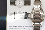 Stainless steel luxury watch case and bracelet close-up on vintage watch print background
