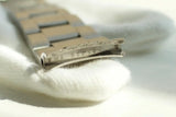 Close-up of stainless steel watch bracelet end link with engraved number MA93250
