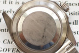 Close-up of stainless steel watch case back with visible scratches and brushed finish