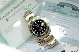 Rolex Submariner Date 16610LV watch with green bezel on stainless steel bracelet, displayed with certificates