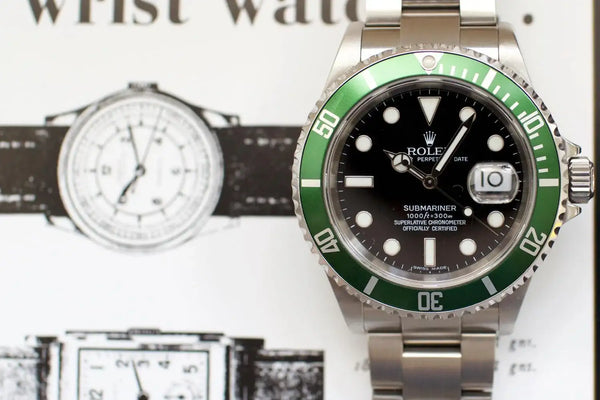 Stainless steel Swiss watch with black dial and green bezel, date display, close-up view