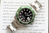 Stainless steel watch with green bezel and black dial on printed certificate background