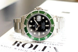 Stainless steel watch with green bezel and black dial on certification paper