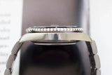 Side view of stainless steel luxury watch case and bezel with metal bracelet