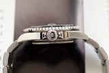 Close-up side view of a luxury stainless steel watch with a crown and bracelet