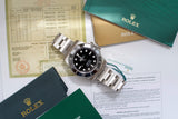 Stainless steel black dial dive watch with paperwork and green certificate folders