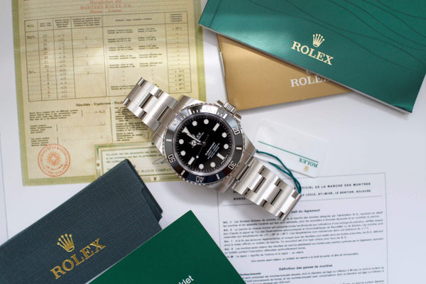 Stainless steel black dial dive watch with paperwork and green certificate folders