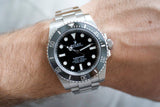 Stainless steel Rolex Submariner No Date luxury watch with black dial worn on wrist