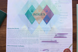 Official Rolex warranty card and chronometer certification document.