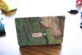 A textured green and brown luxury watch box with a small white identification tag numbered 16613.