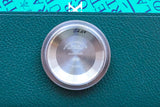 Close-up of the stainless steel case back of a Rolex watch with engravings.