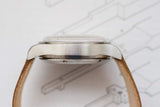 Side profile view of a luxury watch case and leather strap