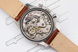 Rear view of a luxury Swiss watch showing the intricate mechanical movement and leather strap.