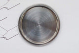 Close-up of a brushed stainless steel watch case back