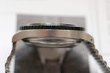 Close-up side view of a stainless steel pilot chronograph watch case and bezel