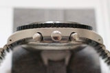 Side view of stainless steel pilot chronograph watch with bezel and pushers