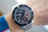 Vintage pilot chronograph watch with black bezel and tritium lume on wrist
