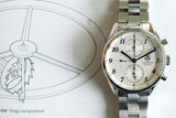 TAG Heuer Carrera automatic watch with a white dial on a stainless steel bracelet.