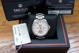 Silver Swiss-made luxury watch with white dial, date display, and tag, shown in original box