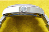 Stainless steel luxury watch side view with engraved crown and metal bracelet