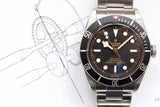 Stainless steel black dial automatic watch with rotating bezel on technical drawing background