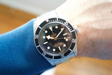 Stainless steel black dial 41mm automatic Swiss watch with rotating bezel on wrist