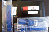 Tudor Pelagos 25600TB blue rubber straps, warranty card, and tags on table