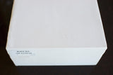 Plain white box with a label reading BLACK SEA SAP 45599.04, on a dark surface