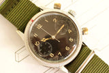 Vintage pilot watch with black dial, luminous numerals, and green fabric strap