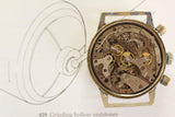 Close-up of vintage mechanical watch movement with exposed gears and intricate components