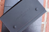 Close-up of a grey leather Vacheron Constantin Genève luxury watch case.