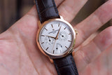 Vacheron Constantin luxury watch with rose gold case and brown leather strap on a hand