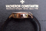 Side view of a Vacheron Constantin rose gold luxury watch with a black leather strap.