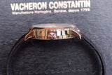 Side view of a gold Vacheron Constantin luxury watch on a textured dark background