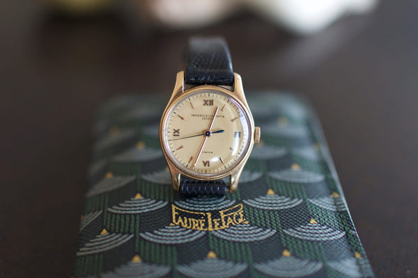 Vintage Vacheron Constantin gold watch with black leather strap on patterned case