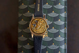 Close-up of luxury Swiss watch open caseback showing exposed mechanical movement on patterned case
