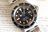 Vintage stainless steel dive watch with black dial, date display, and rotating bezel