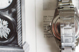 Close-up of vintage stainless steel luxury watch bracelet with clasp and crown logo