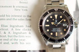 Vintage stainless steel dive watch with black bezel and luminous markers on a bracelet