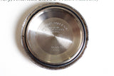 Close-up of stainless steel vintage watch case back engraved with Swiss manufacturer details and model number 1680.