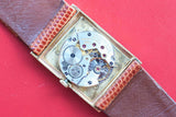 Close-up of a vintage Montres Rolex S.A. mechanical watch movement with brown leather strap