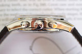Close-up of luxury chronograph watch case side with star crown and leather strap