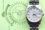 Tudor Prince Date luxury watch with silver dial and steel bracelet on a gear diagram background