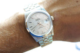 Close-up of a Tudor Prince Date silver luxury watch with a textured dial on a wrist.