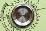 Close-up of the stainless steel case back of a Montres Tudor watch.