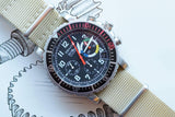 Zenith El Primero luxury chronograph watch with tan nylon strap on a technical drawing.